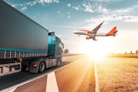 an airplane is flying over a truck on the road