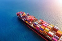 an aerial view of a container ship in the ocean